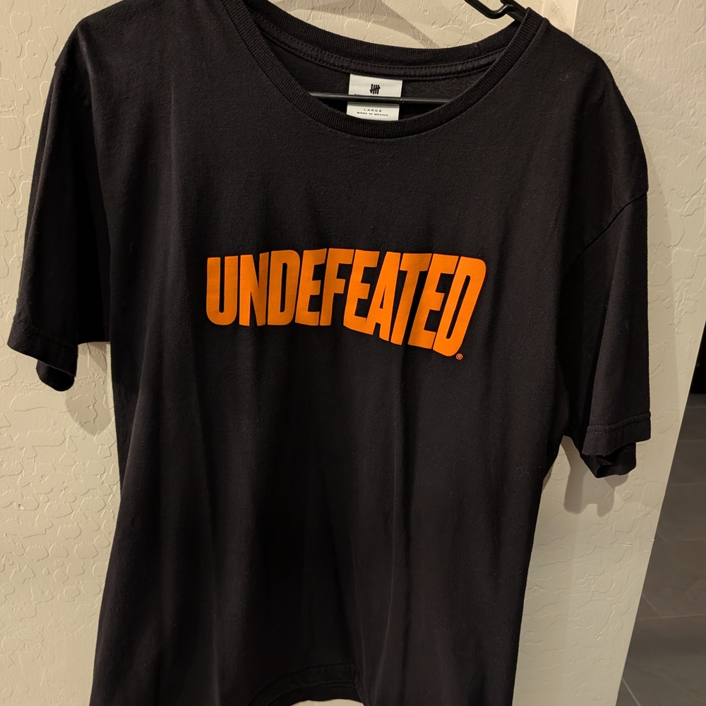UNDEFEATED Black Tee with Bold Orange Logo
